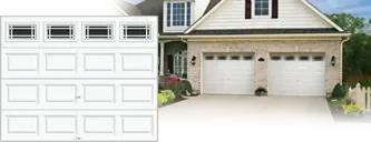 Clopay CLASSIC™ Collection: A white raised-panel door with a row of windows, beside a house with two matching doors.