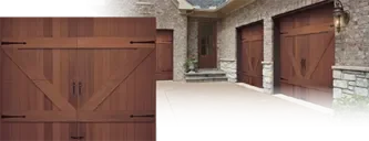 Clopay RESERVE® Collection, Limited Edition Series: A wood carriage house door with black strap hinges, beside a stone house with matching doors.