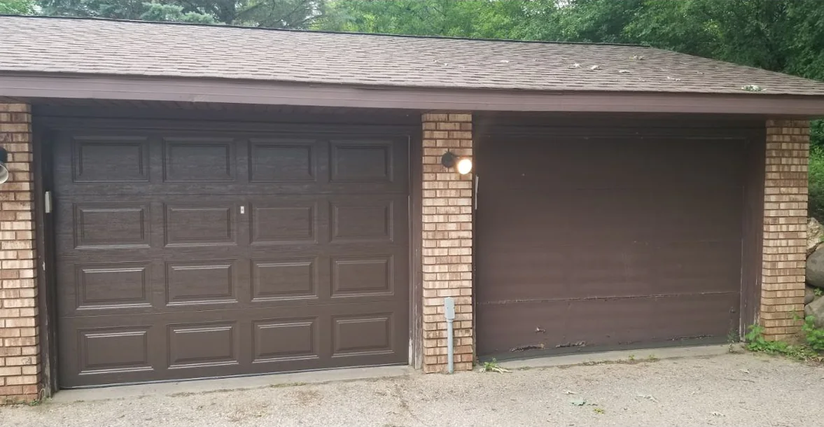 Two garage doors side by side under one roof: a brown raised-panel door on the left and a worn, dented brown flat door on the right.
